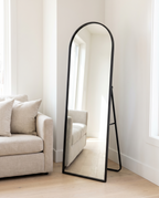 Arched Metal Full-Length Mirror, black stand, standing in bright living room