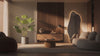 Ravellora editorial living room styled with walnut wall panel, LED mirror, oak coffee table, and faux monstera